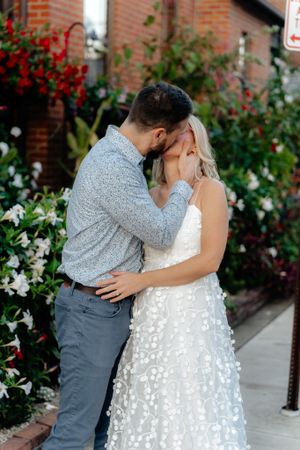 An intimate moment shared between a couple among blooming garden flowers.
