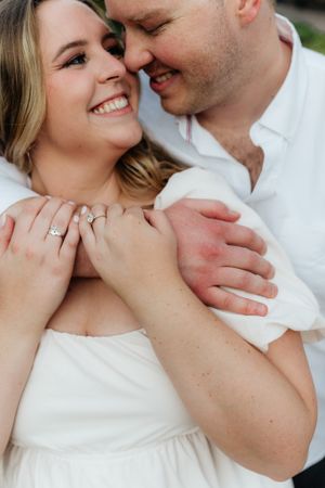 Intimate close up portrait showcasing engagement ring and genuine emotion.