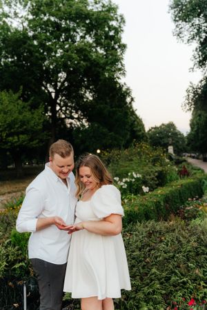 Joyful moment shared in a lush garden setting during engagement session.