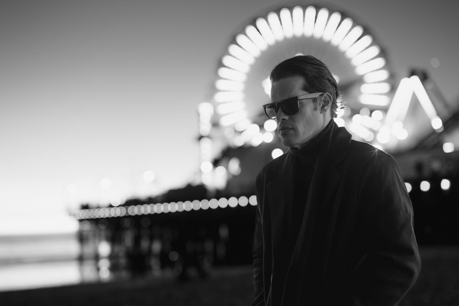 Atmospheric black and white photography with bokeh lights and silhouettes.
