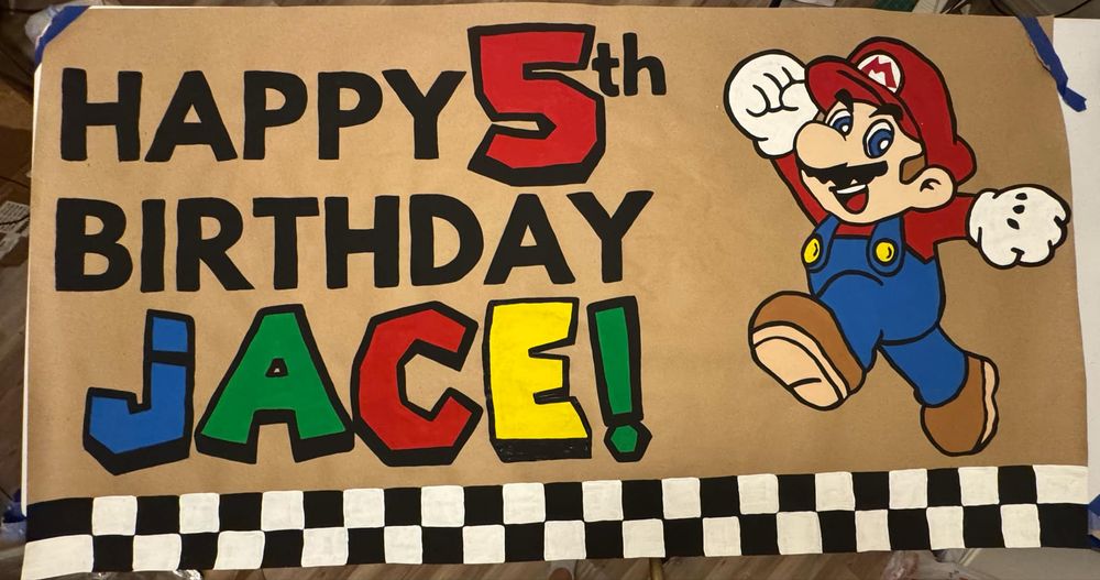 Hand painted Mario birthday banner by Art by Summer Judd.