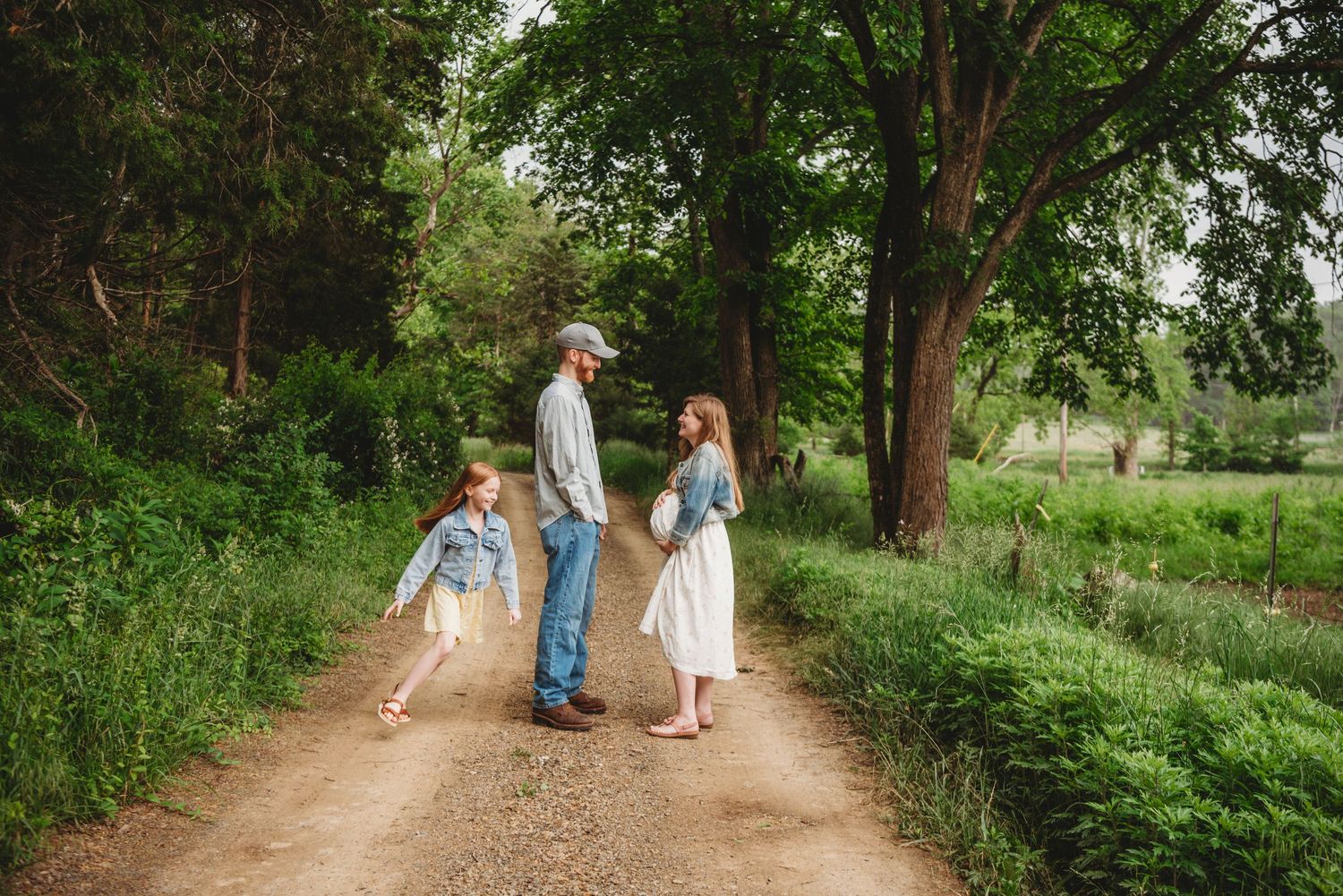 Candid family moment captured while walking along a rustic country path.