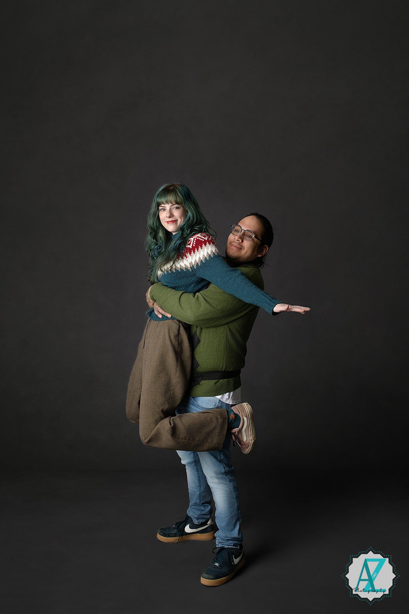 Playful sequence shows two people in casual attire performing a fun spinning lift dance move against dark background.