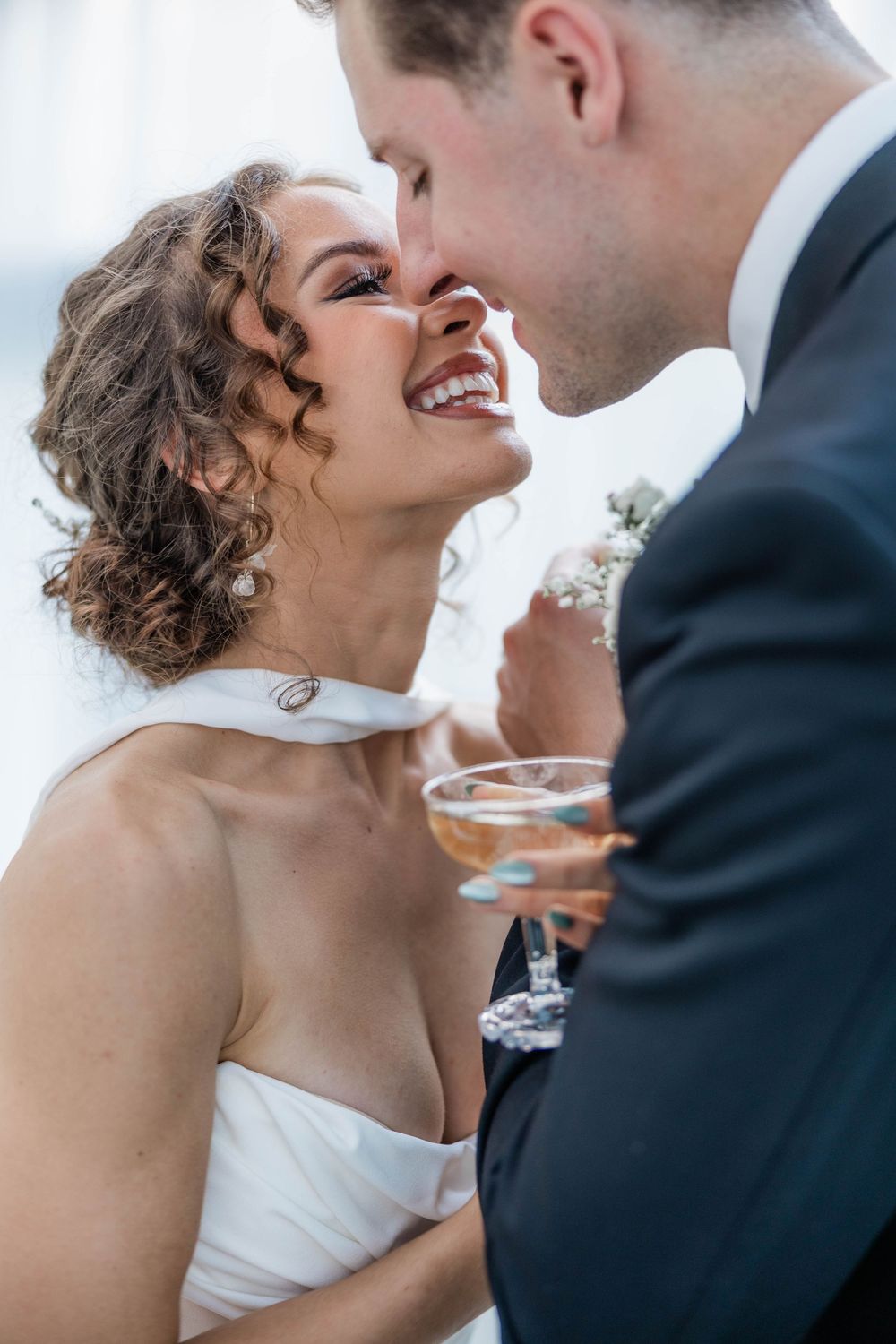 Intimate moment between newlyweds sharing champagne during their wedding celebration.