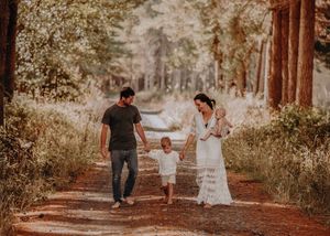 Five distinct images of a family walking hand-in-hand down a forest trail in golden afternoon light. Photographed in a Forest