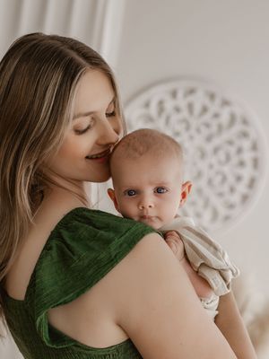 Series of intimate portraits showing tender moments between parent and baby against a light neutral background.