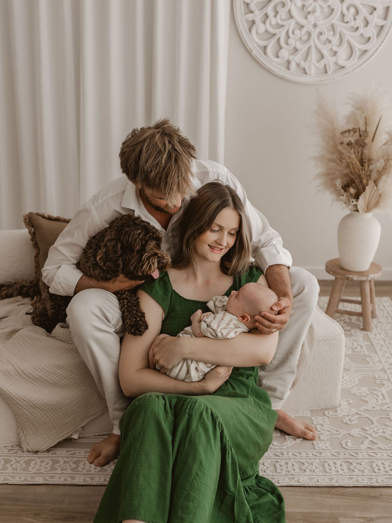A series of intimate photos showing a couple in white and green dresses embracing on a light-colored floor with minimal decor.