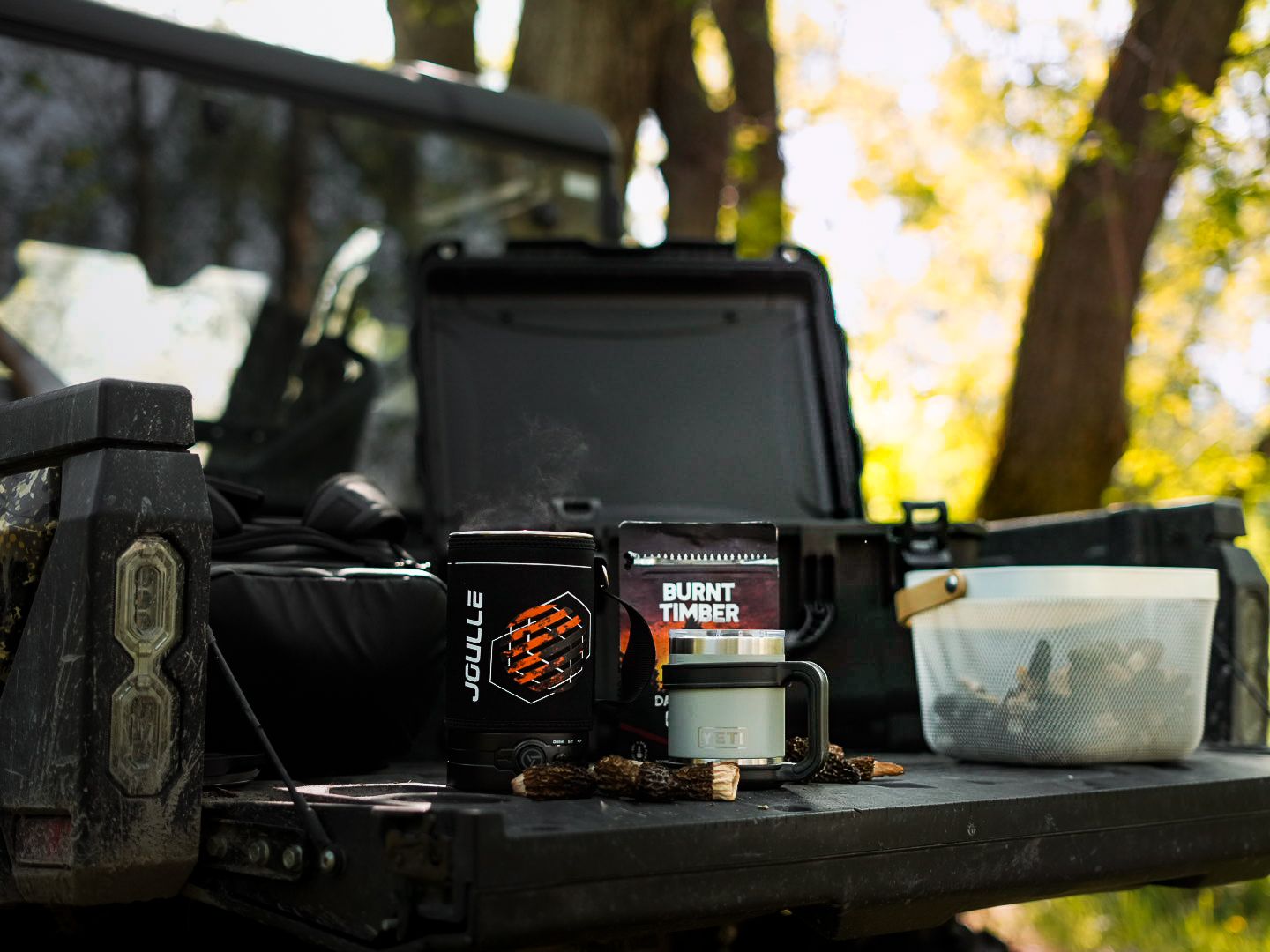 Outdoor coffee preparation scene with equipment on dark table.
