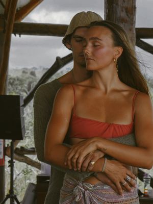 Relaxed moment captured in natural light under wooden shelter.