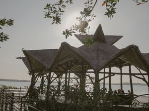 Star-shaped architectural details on beach structure silhouetted against evening sky.