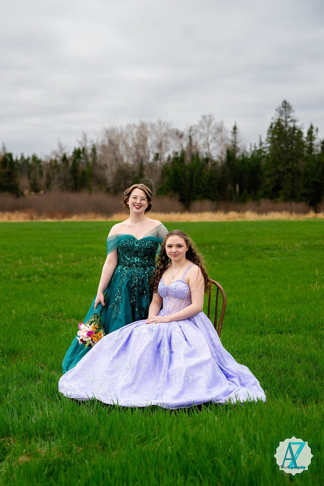 Two formal gowns sparkle in a grassy field, one in emerald sequins and one in lavender with a full skirt.