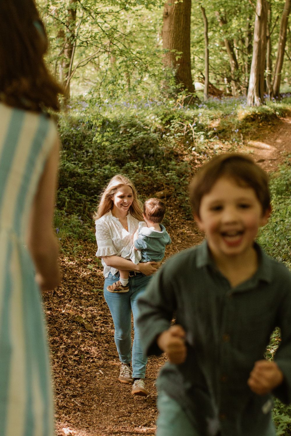 Candid moment of joy and laughter on a forest walking trail.