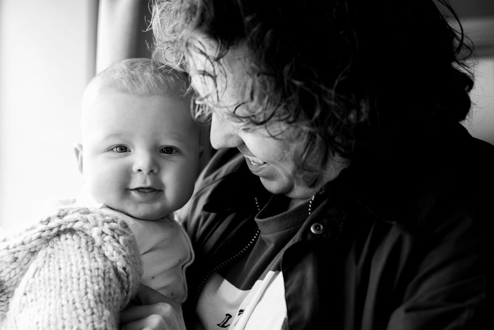 Tender black and white moment captured in dramatic lighting.