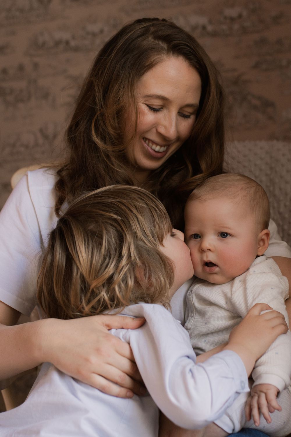 Intimate indoor portrait with soft lighting and white clothing.