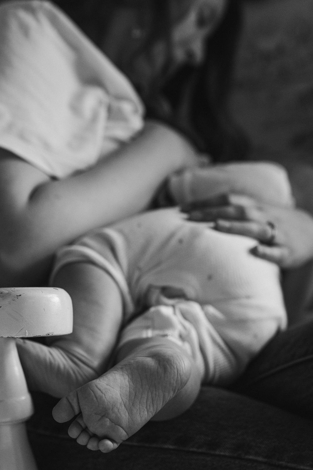 Close-up black and white photo of hands tenderly holding each other in sequence.