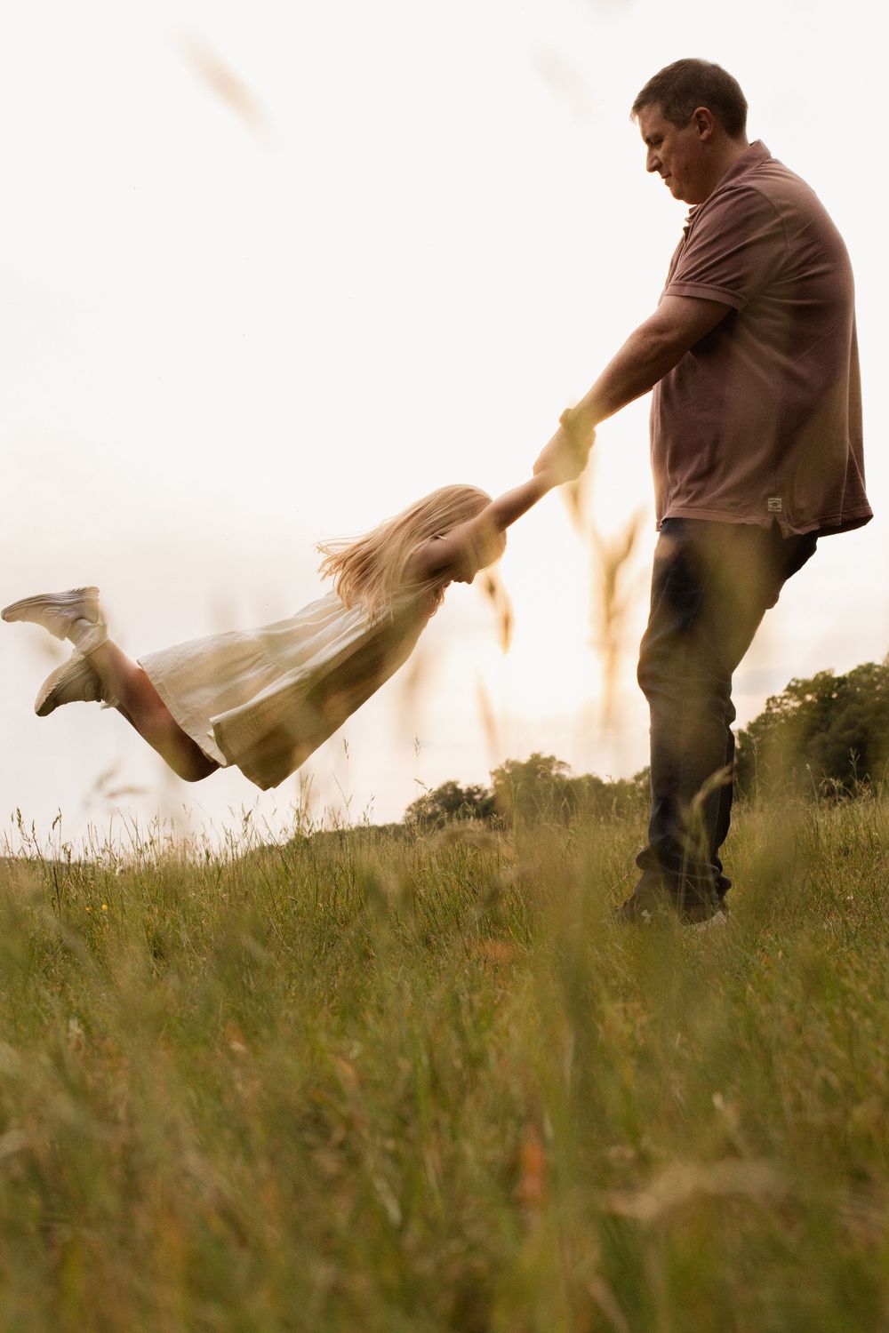 Dynamic sequence showing movement across a grassy field during golden hour.