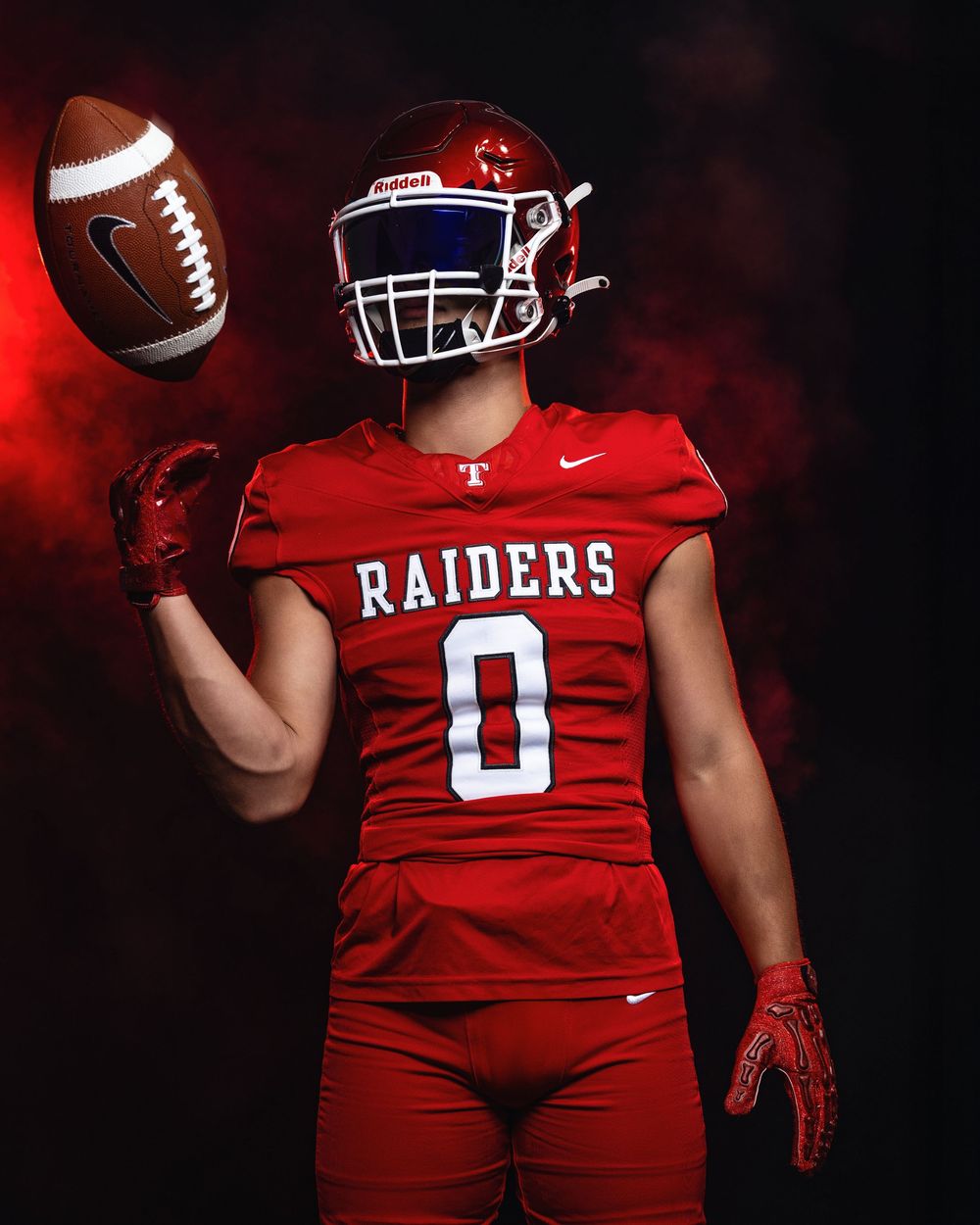 A series of four football players in red uniforms pose with footballs against a dark background.