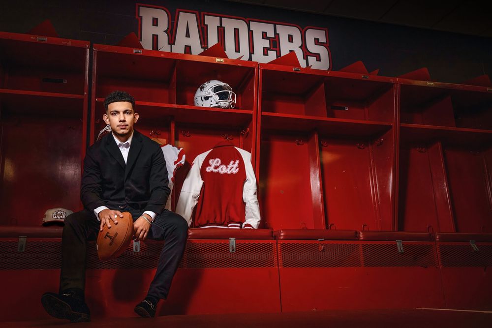 Red Raiders locker room interior showing empty locker stalls with jerseys and equipment in dramatic lighting.