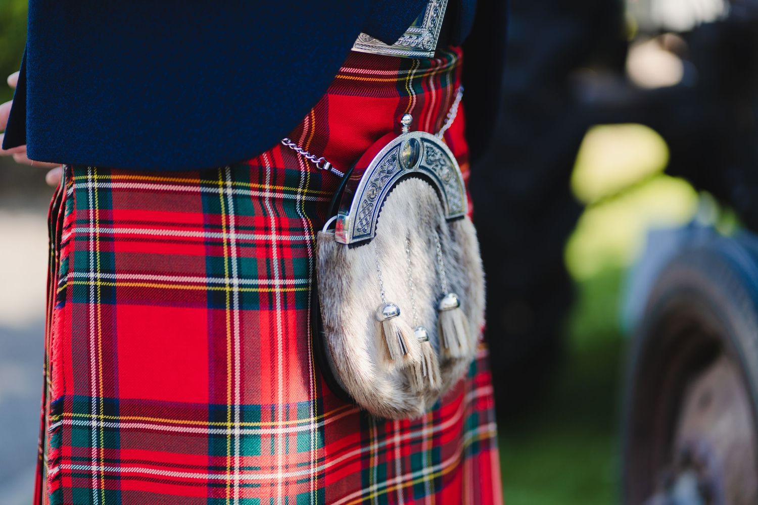 Traditional Scottish sporran pouch attached to a red tartan kilt.