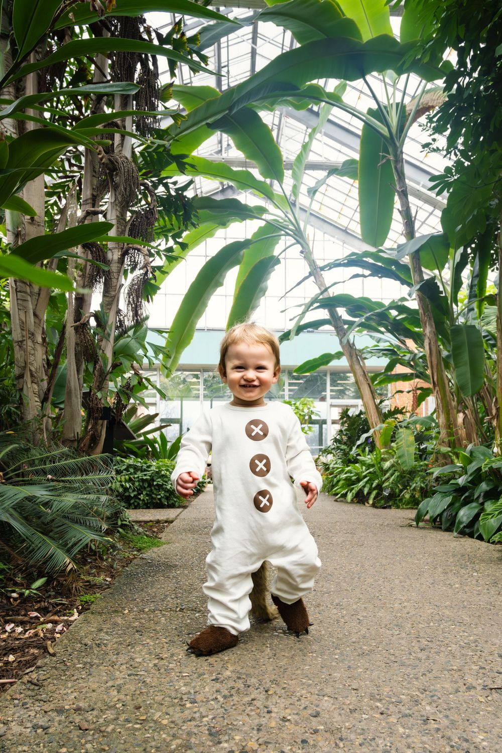 Cheerful toddler photos with baby running in botanical garden – Southeast Michigan lifestyle photography