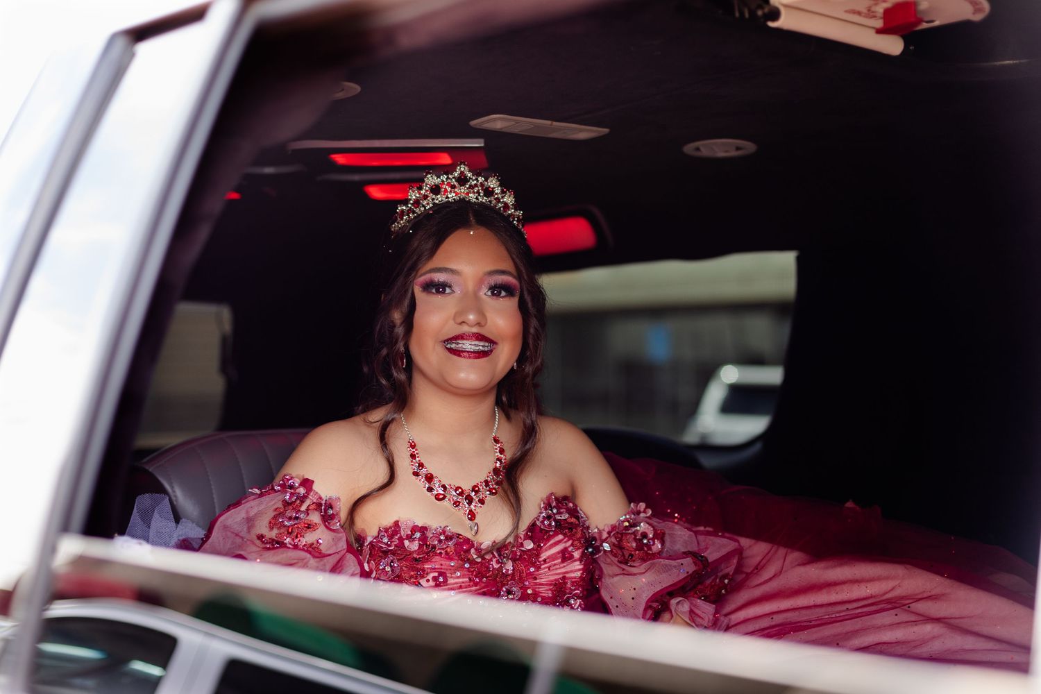 Elegant quinceañera portrait taken through a car window.