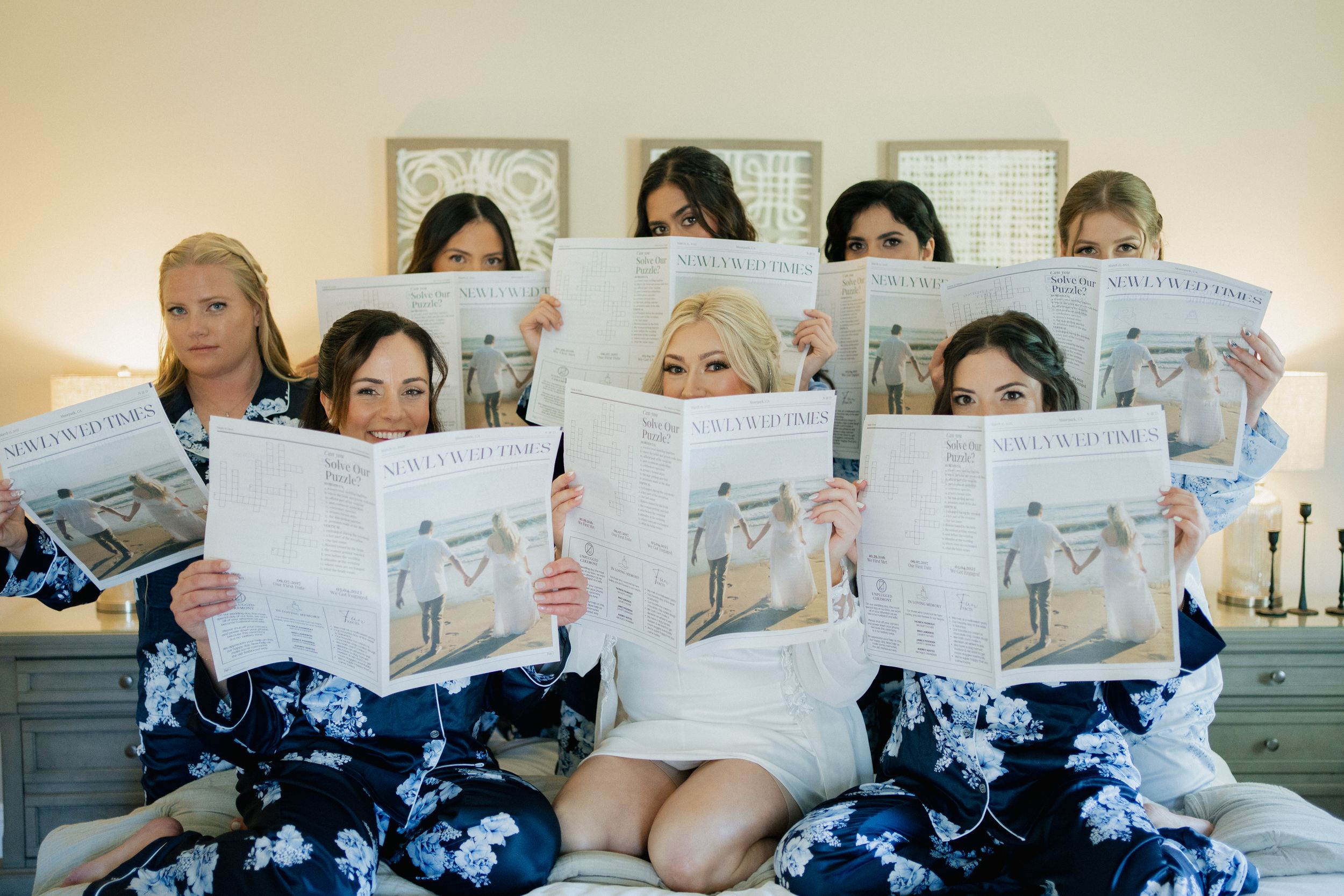 A group of people sitting together and reading newspapers in a coordinated setup.