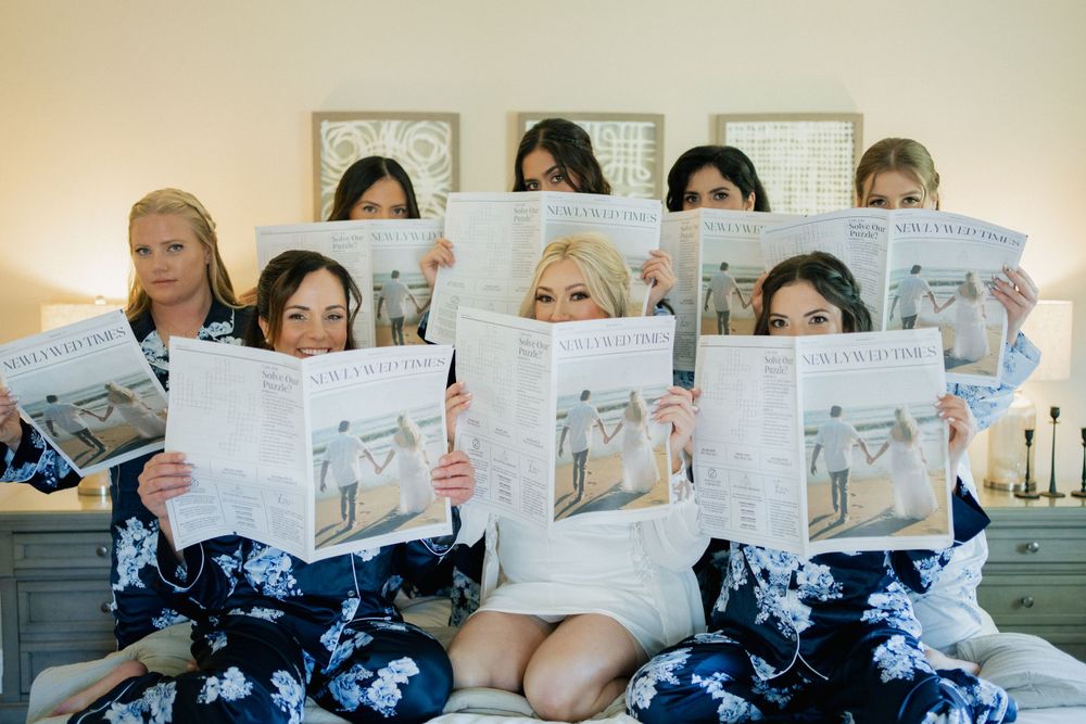 A group of people sitting together and reading newspapers in a coordinated setup.