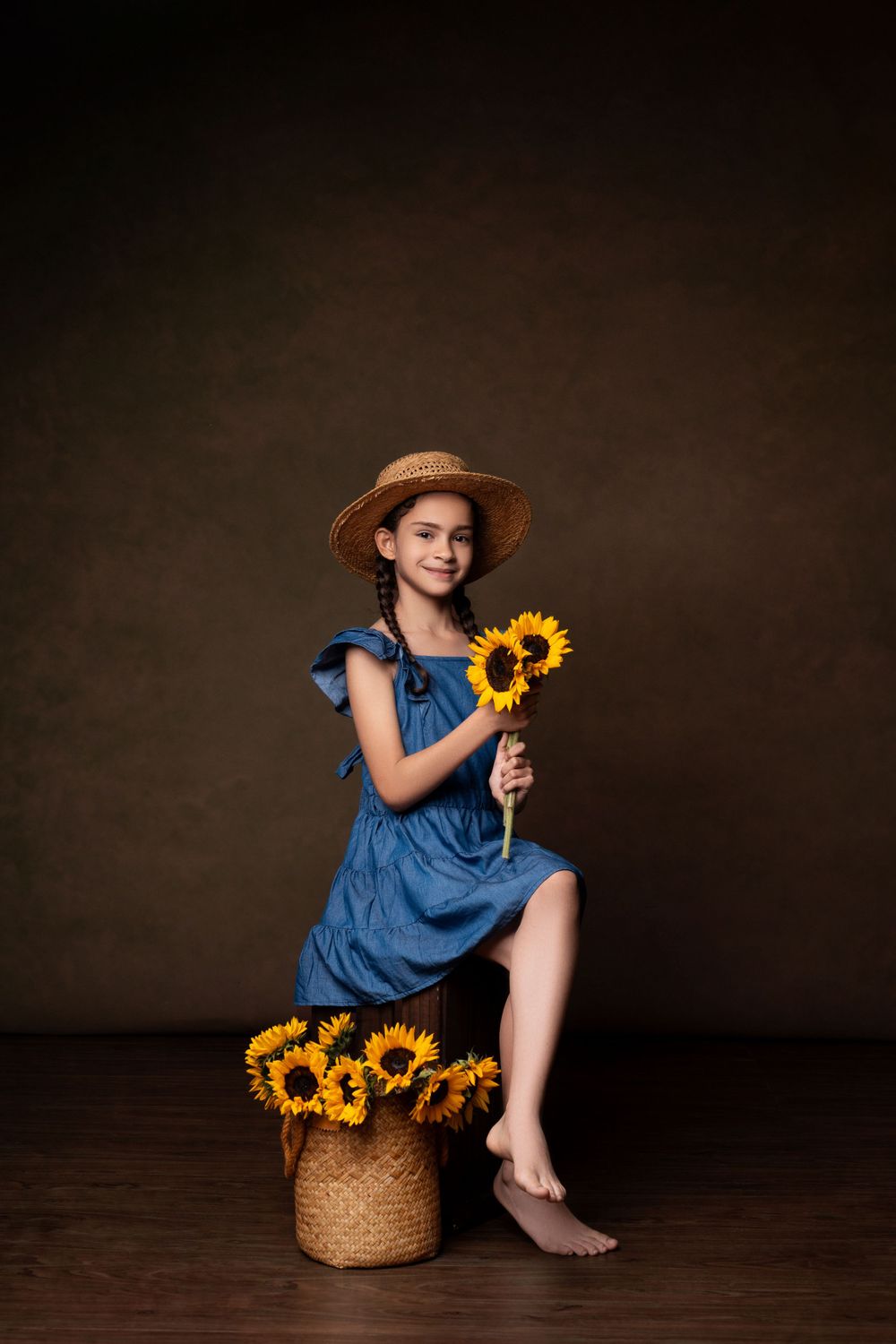 Artistic portrait with sunflowers and woven basket against dark background.