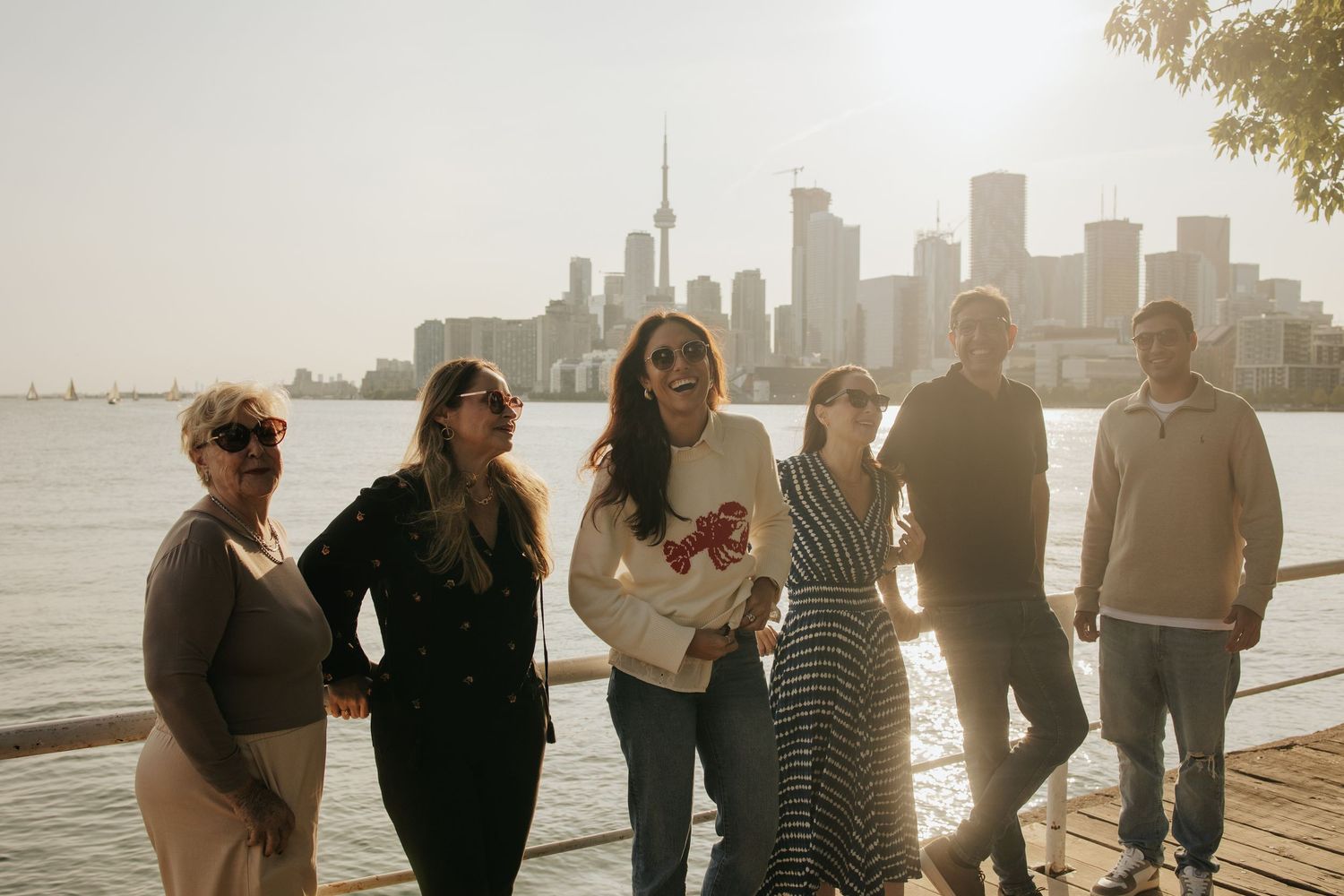 family of six admiring Toronto landscape from Polson Pier