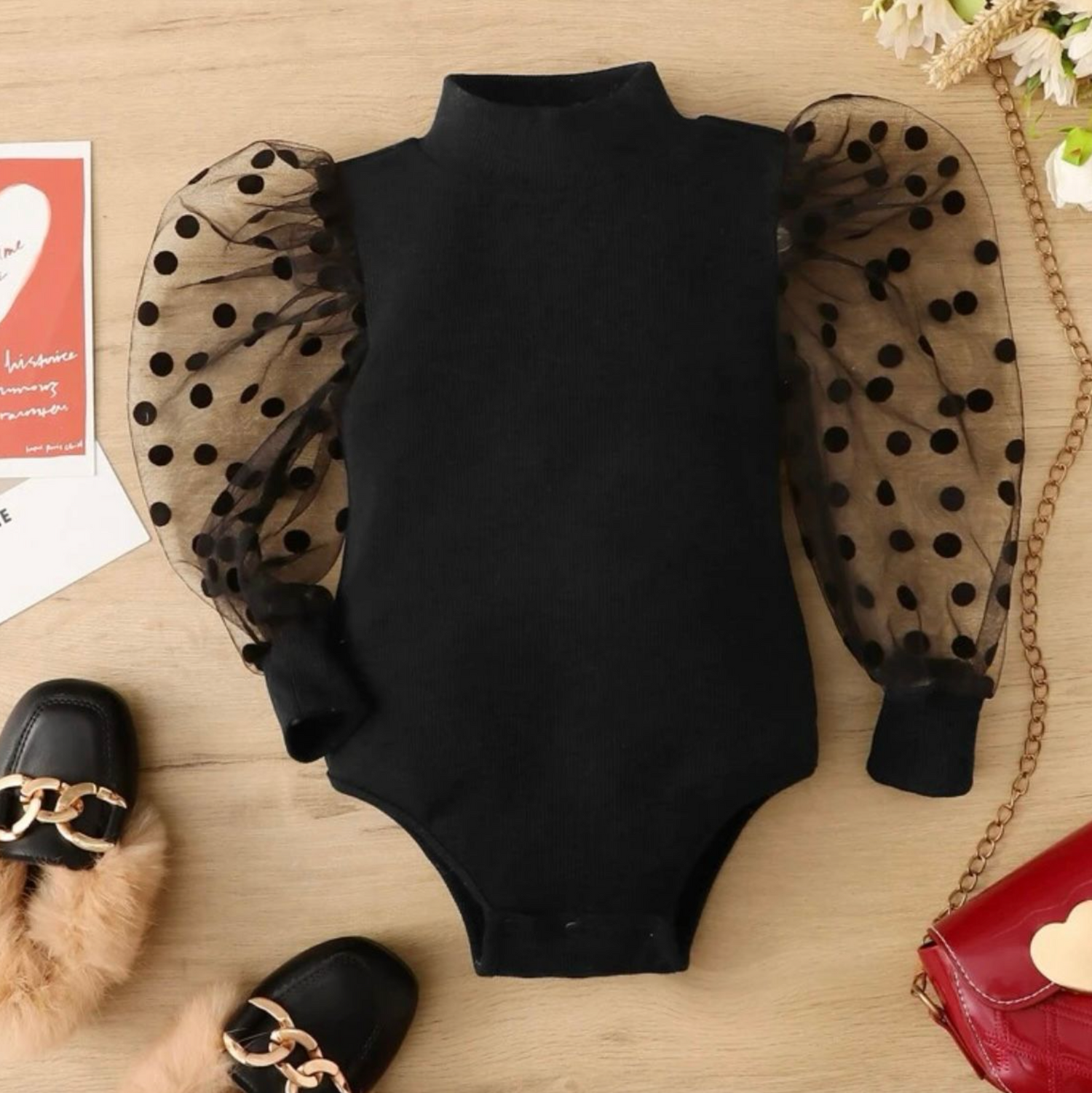 Black baby sweater with polka dot sheer puff sleeves displayed in multiple angles.