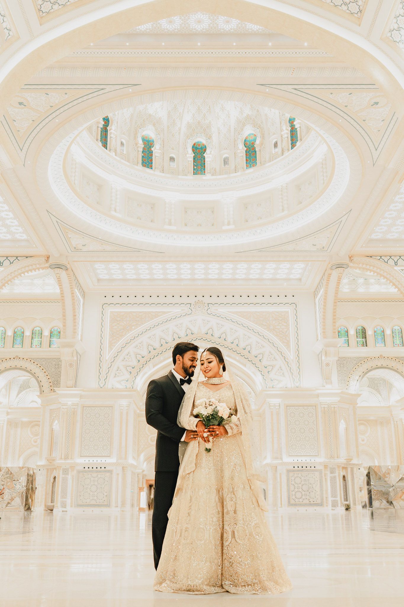 Intimate wedding dance captured in grand chandelier hall