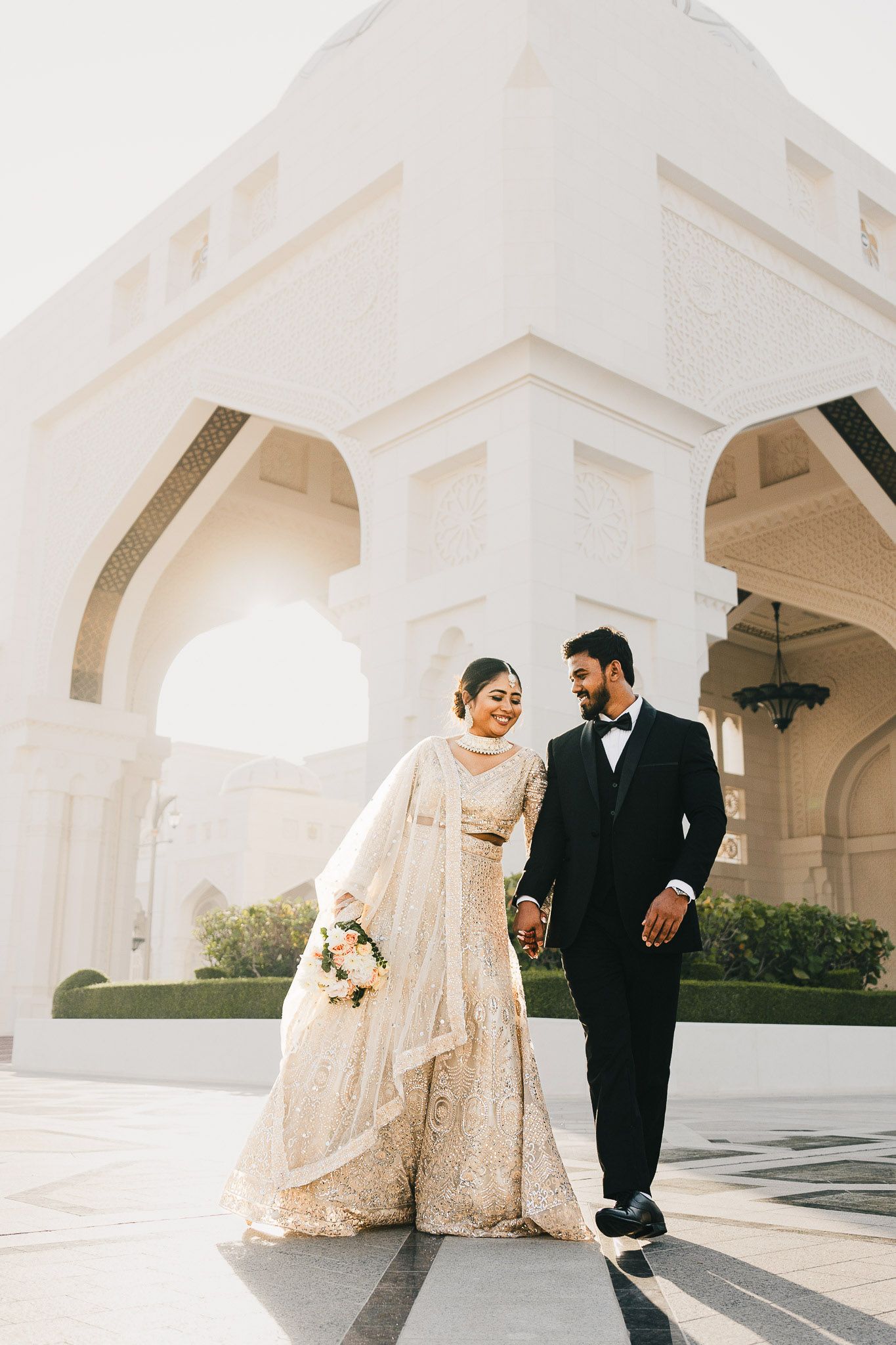 Bride and groom portrait with elegant Middle Eastern architecture backdrop