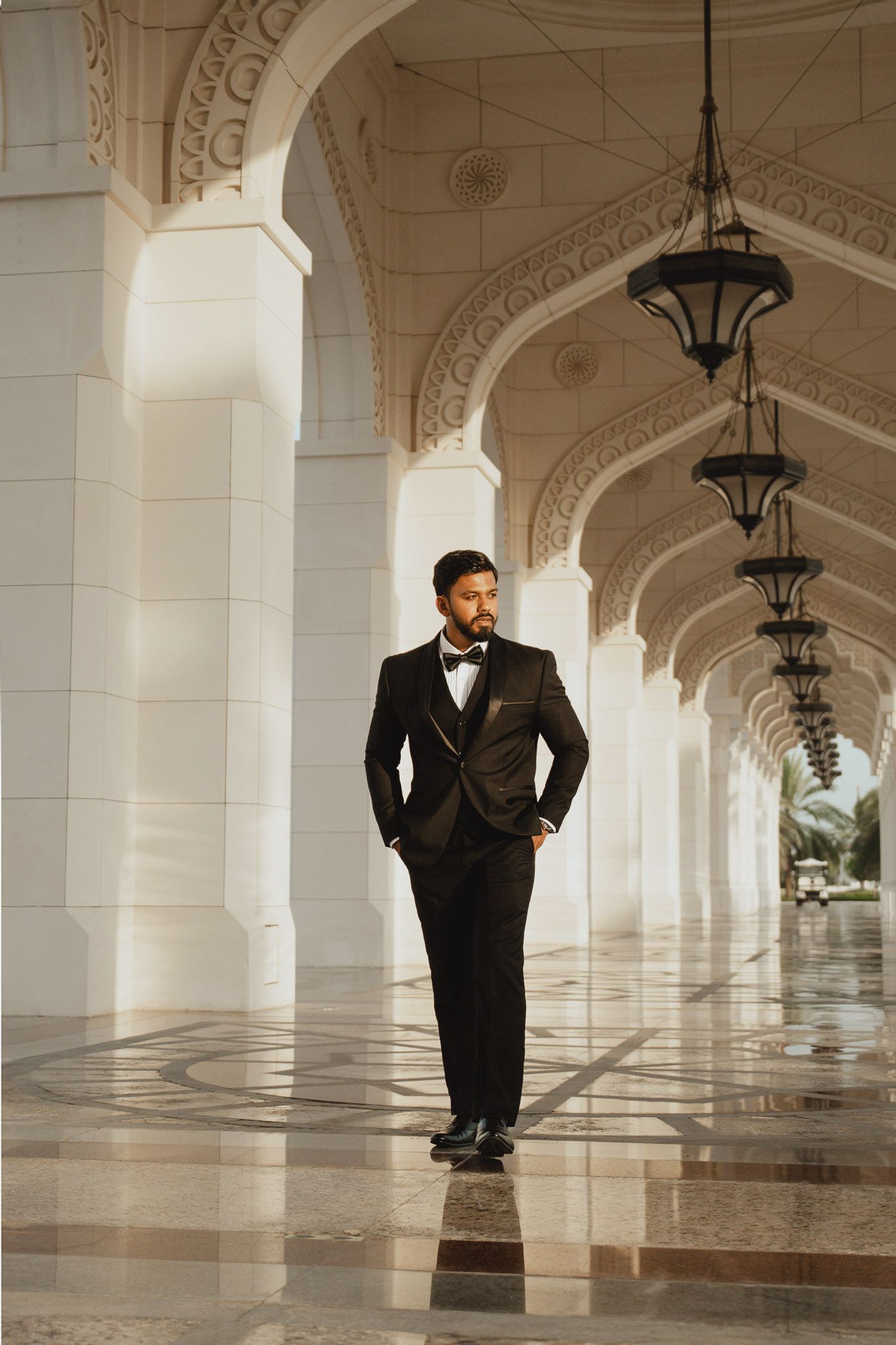 Groom portrait in elegant architectural corridor
