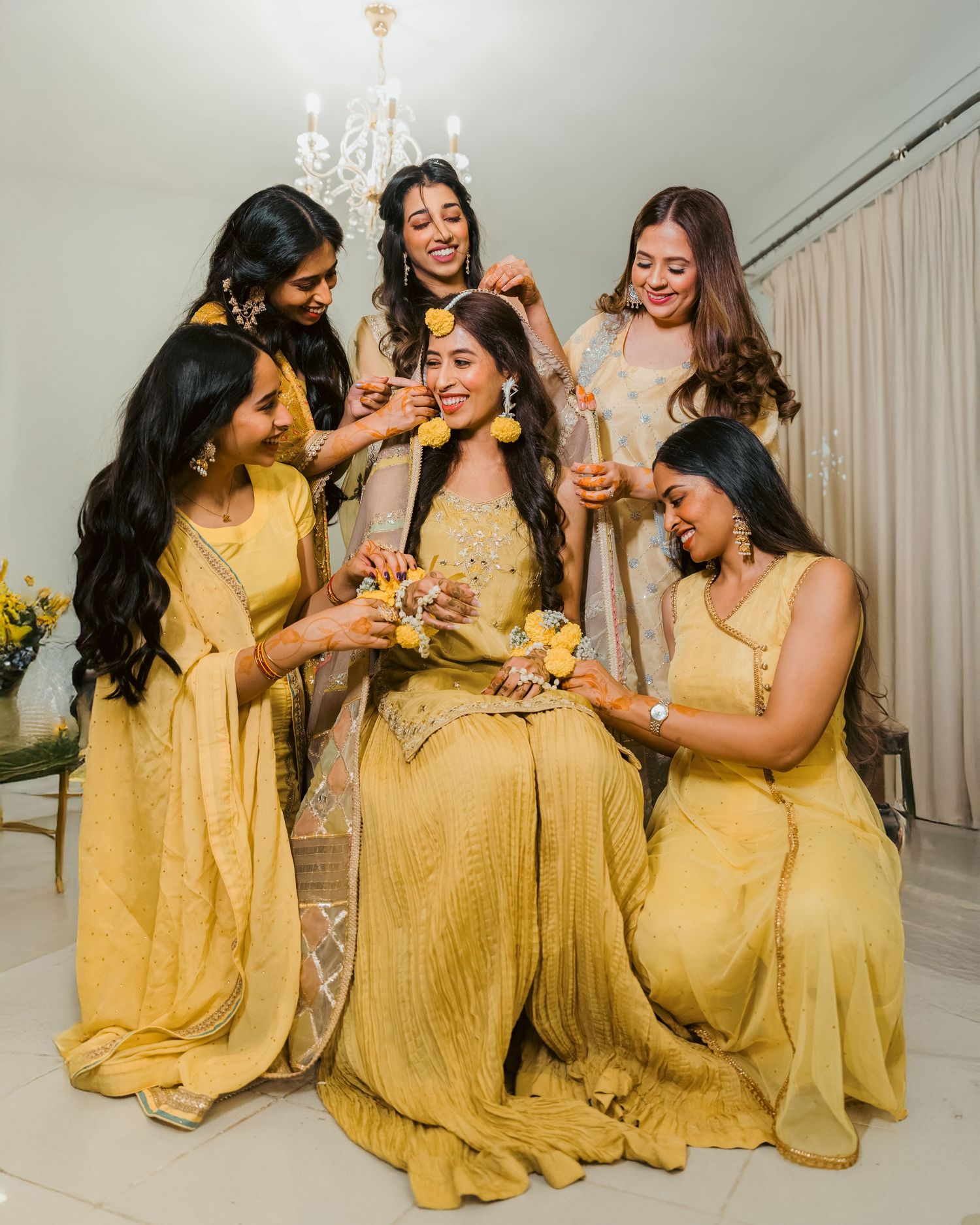 Bridesmaids celebrating with bride during cultural wedding festivities