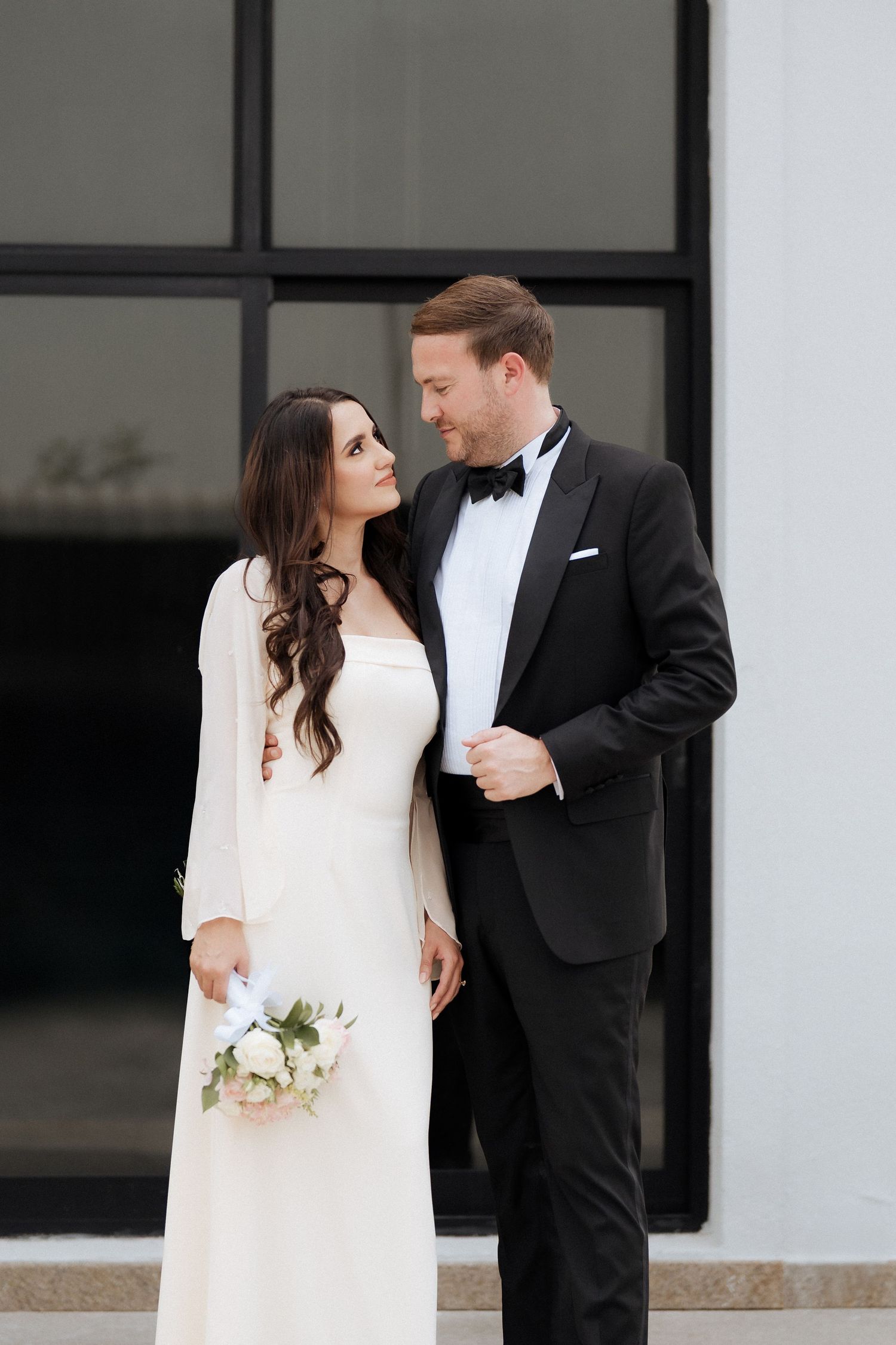 Modern civil wedding couple photoshoot outside contemporary venue