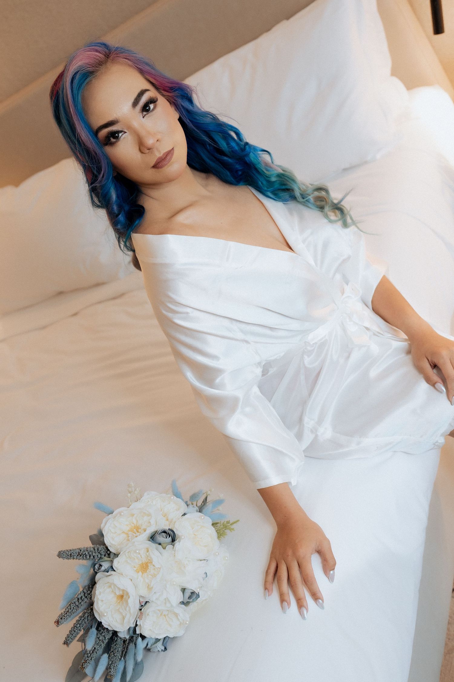 Bride in white robe during wedding morning preparation photos in Dubai