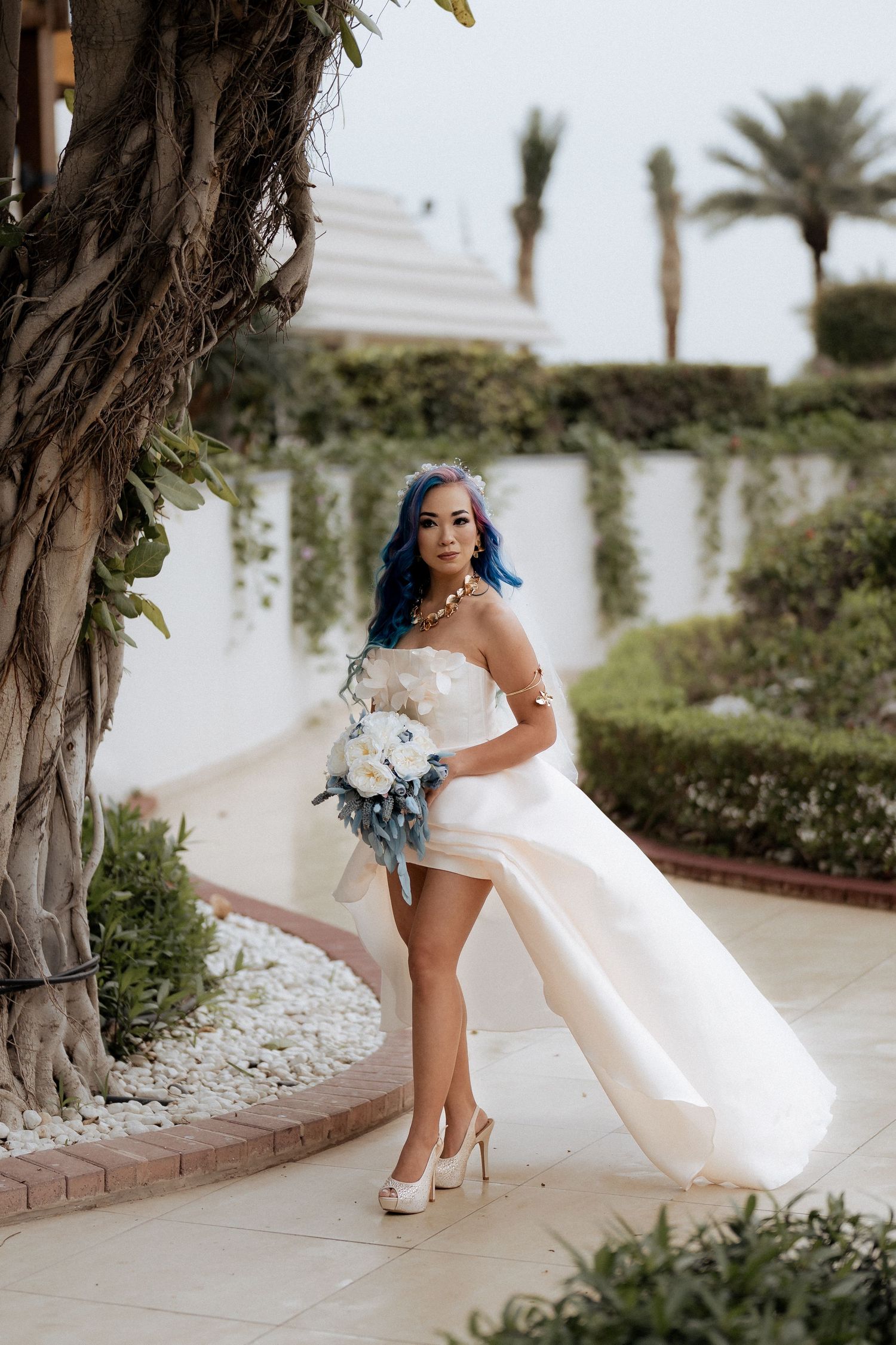 Bride walking with bouquet at luxury outdoor wedding venue in Dubai
