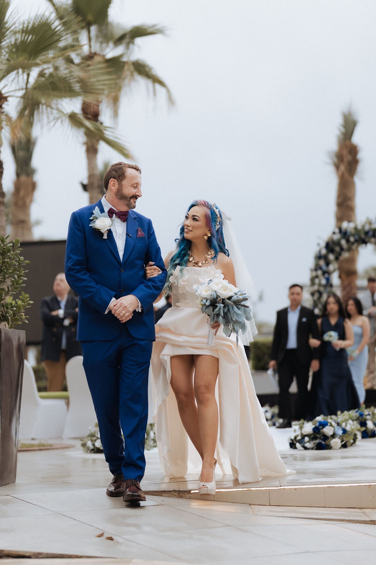 Bride and groom walking together after outdoor wedding ceremony in Dubai