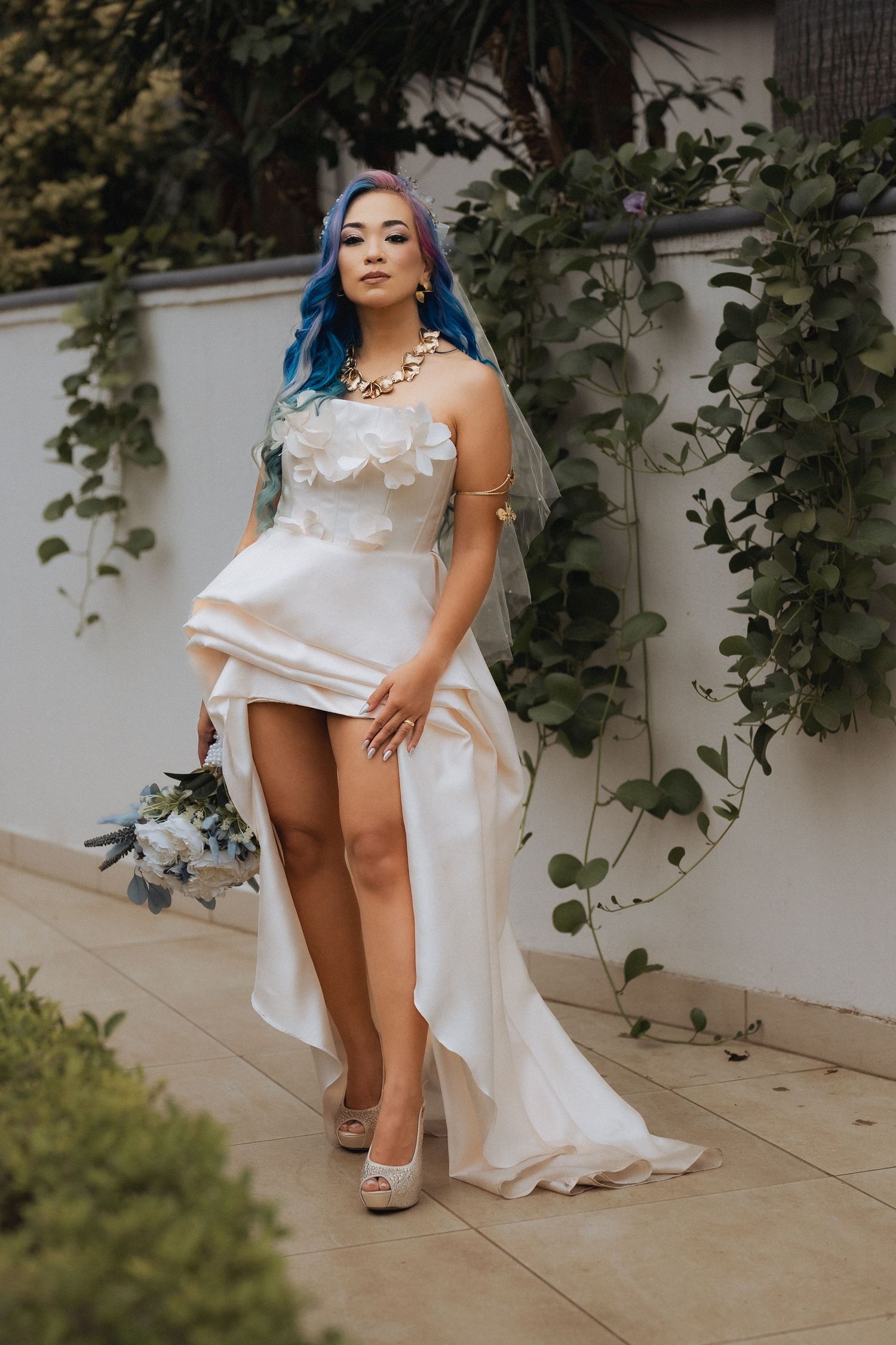 Bride portrait in modern wedding dress holding bouquet at Dubai wedding venue