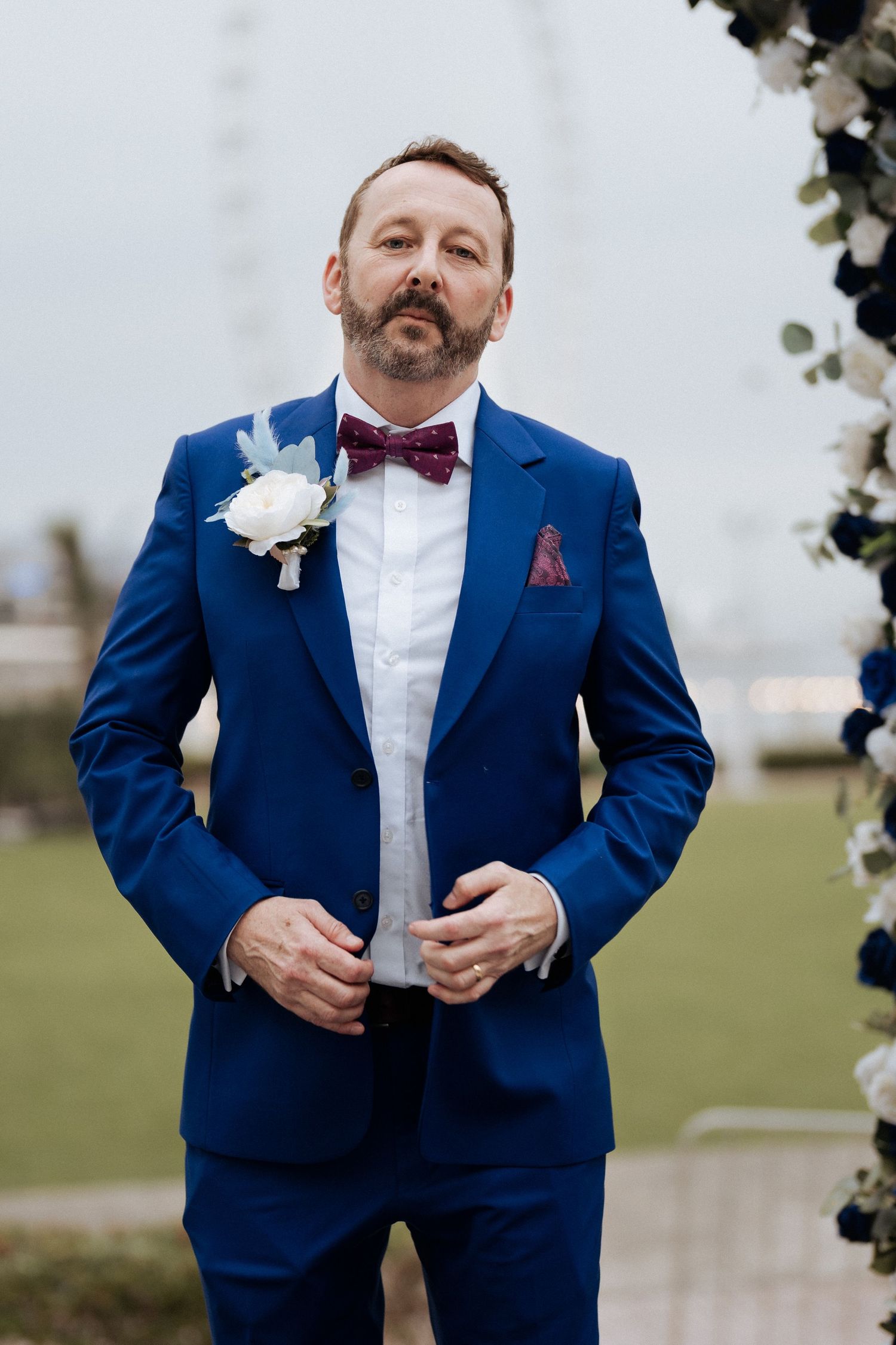 Groom portrait in blue suit during outdoor wedding ceremony in Dubai