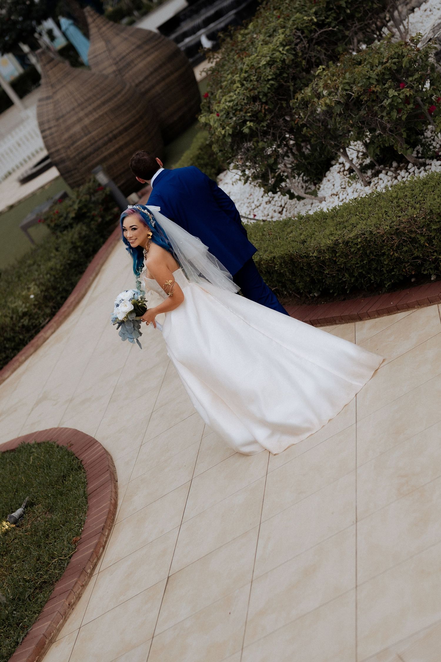 Bride and groom walking together outdoors during wedding ceremony at Dubai wedding venue