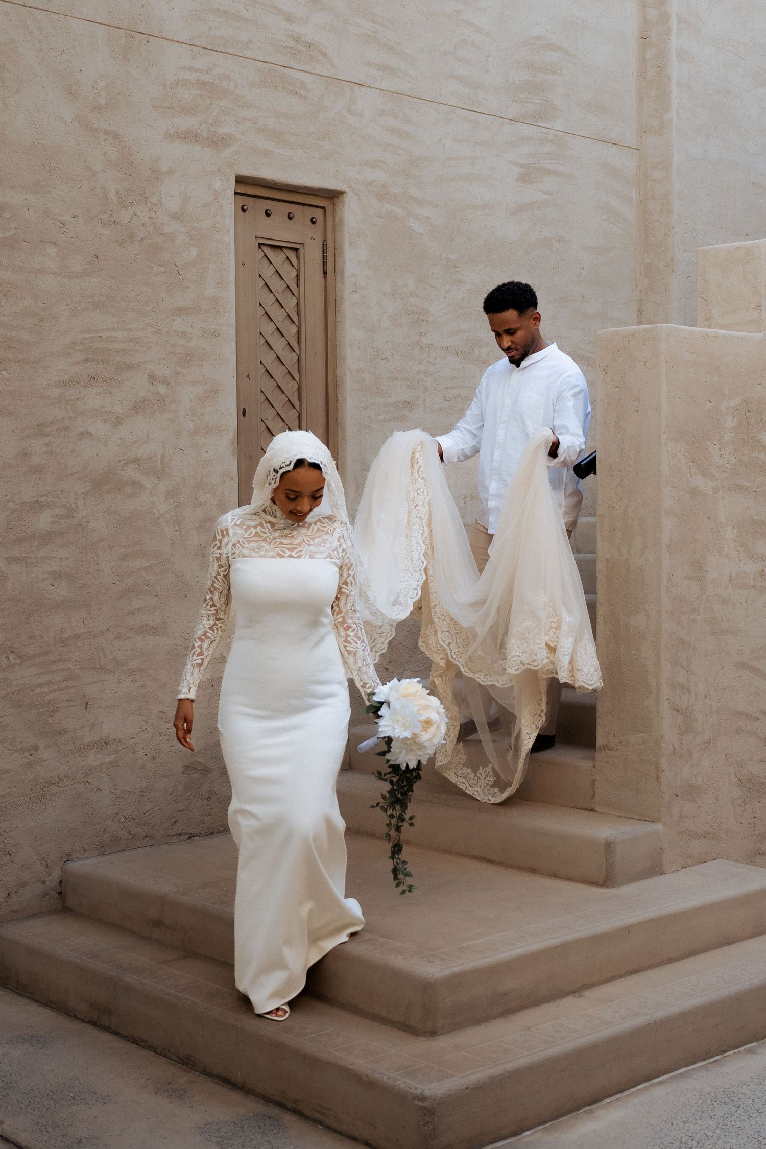 Pre-wedding photoshoot in Dubai – couple in wedding attire walking together