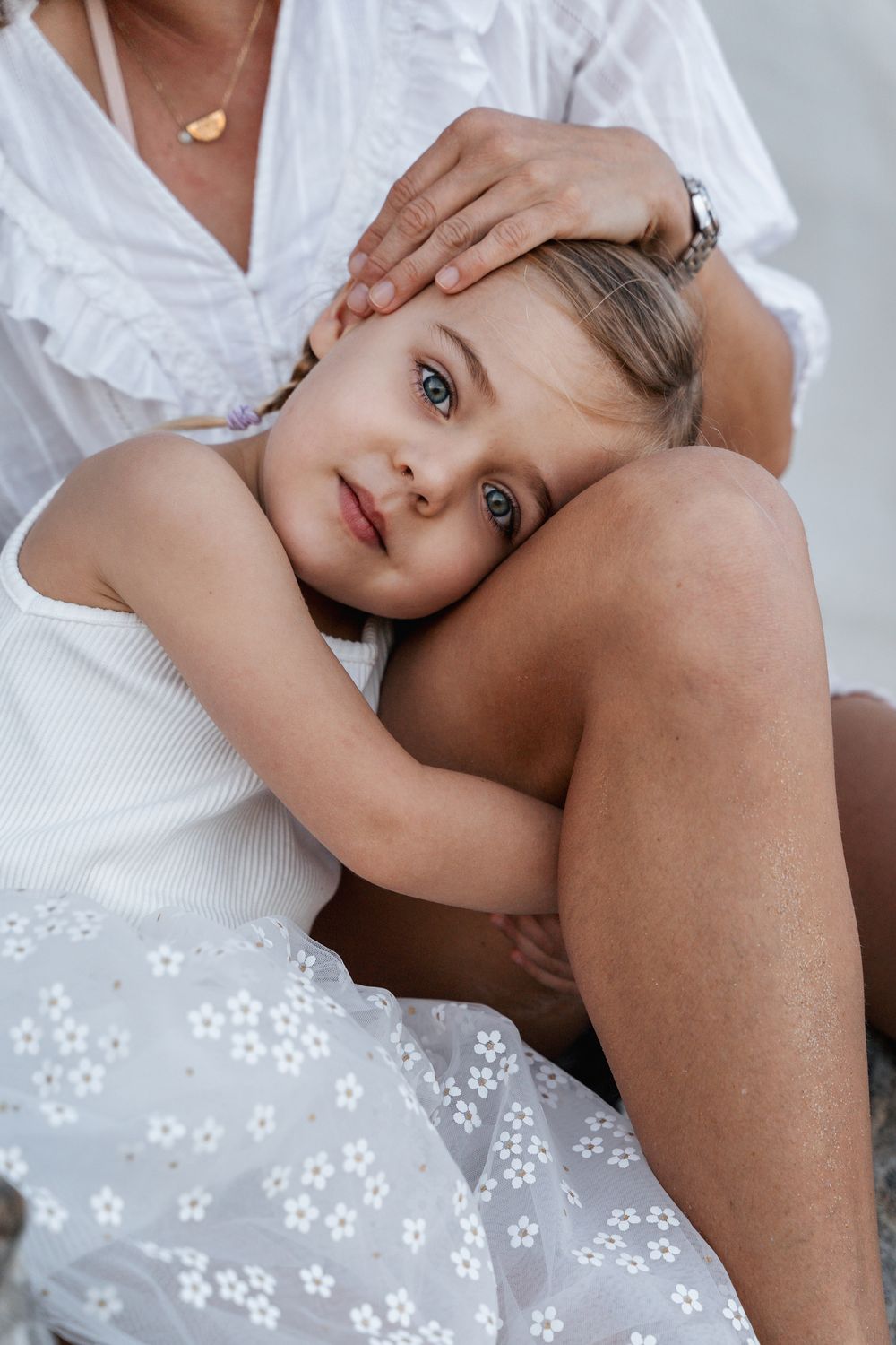 close up photo of a girl hugging her mom's leg during a family photoshoot in North Curl Curl