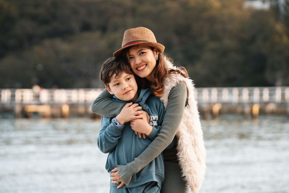 Mom hugs son during a family photoshoot in the northern beaches Mosman Clifton Garden