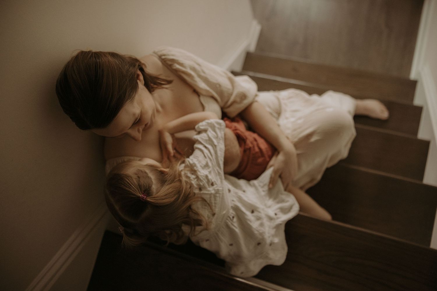 A series of romantic boudoir photographs showing intimate moments in soft, moody lighting.