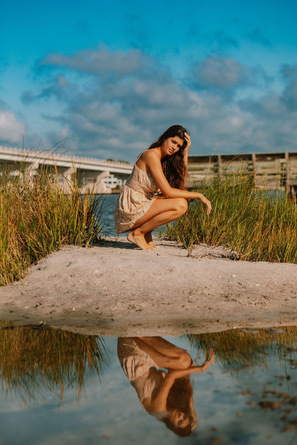 Senior portrait session on the sound side of Surf City, NC, featuring a natural coastal backdrop and golden light.