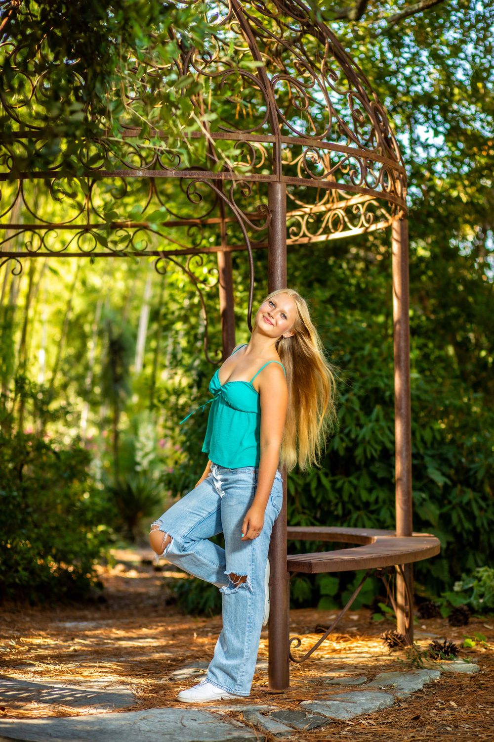 Senior girl posing among beautiful gardens in Hampstead, NC, during a natural outdoor senior photography session.