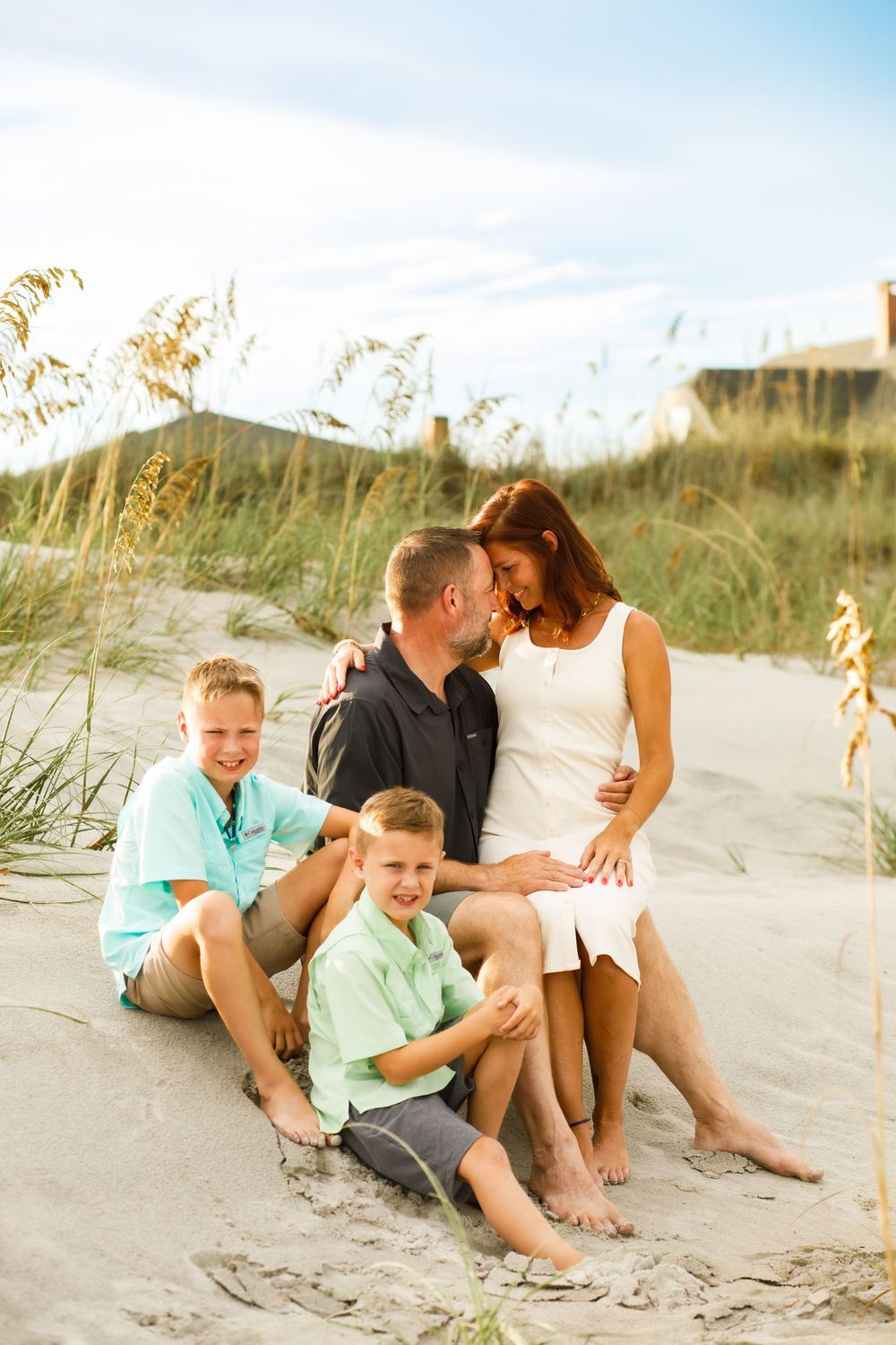 Family of four with two young boys enjoying a beach photography session at Topsail Beach, NC