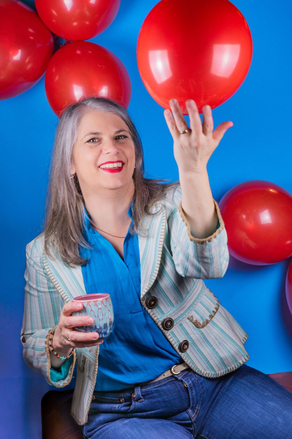 Creative, colorful, professional headshot with bright colors and balloons