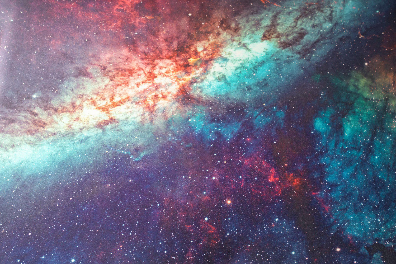 Colorful galaxy nebula with red, blue, and purple stars in space.